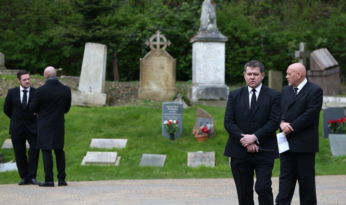 Private security guards stand outside Highgate Cemetery in London