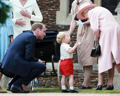 Prince George of Cambridge talks to Queen Elizabeth outside the Church of St Mary Magdalene on the Sandringham Estate for the Christening of Princess Charlotte of Cambridge