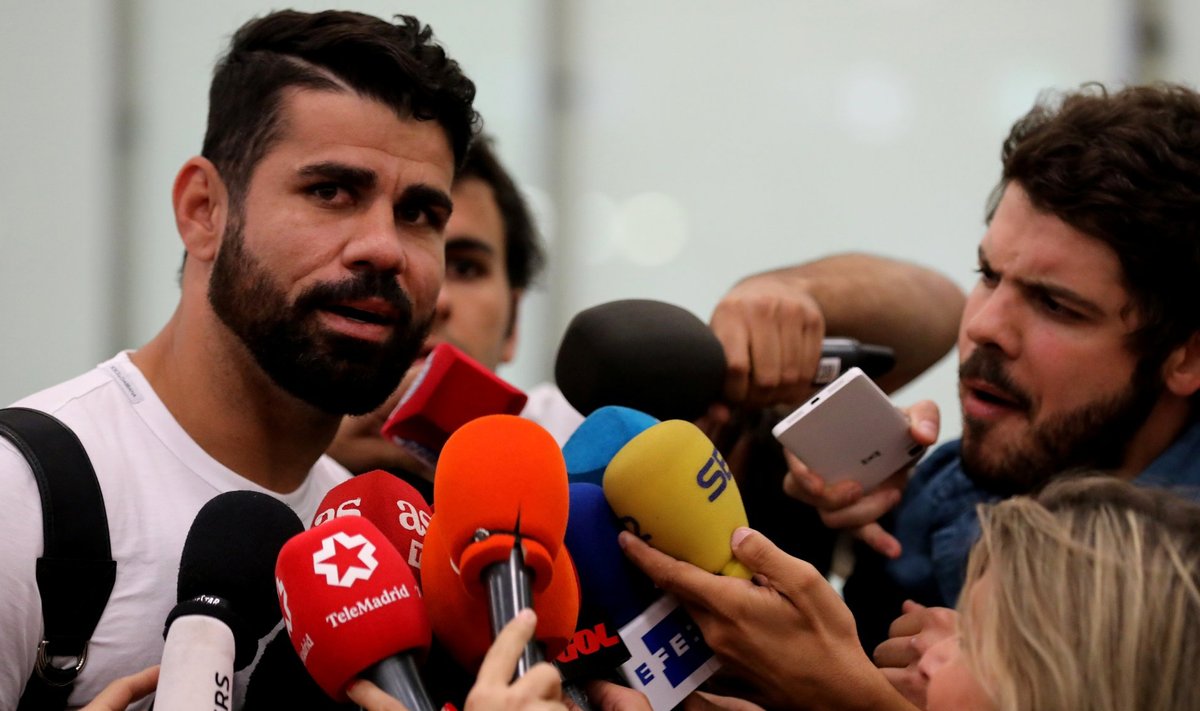 Spain's soccer player Costa speaks to media upon arriving at Adolfo Suarez Madrid Barajas airport in Madrid