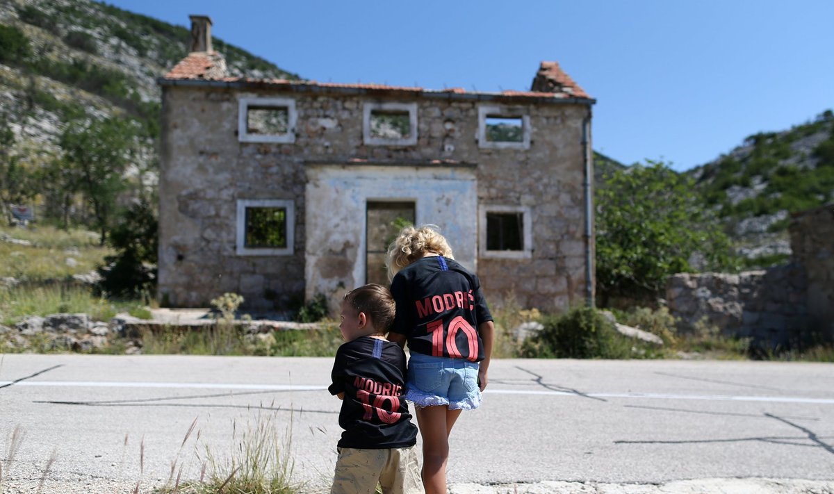 Kids are seen in front of Luka Modric's birth house in Modrici village