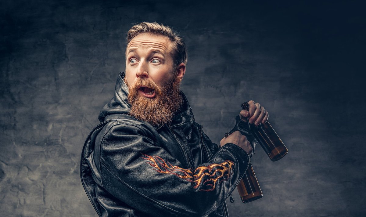 A man holds beer bottle.