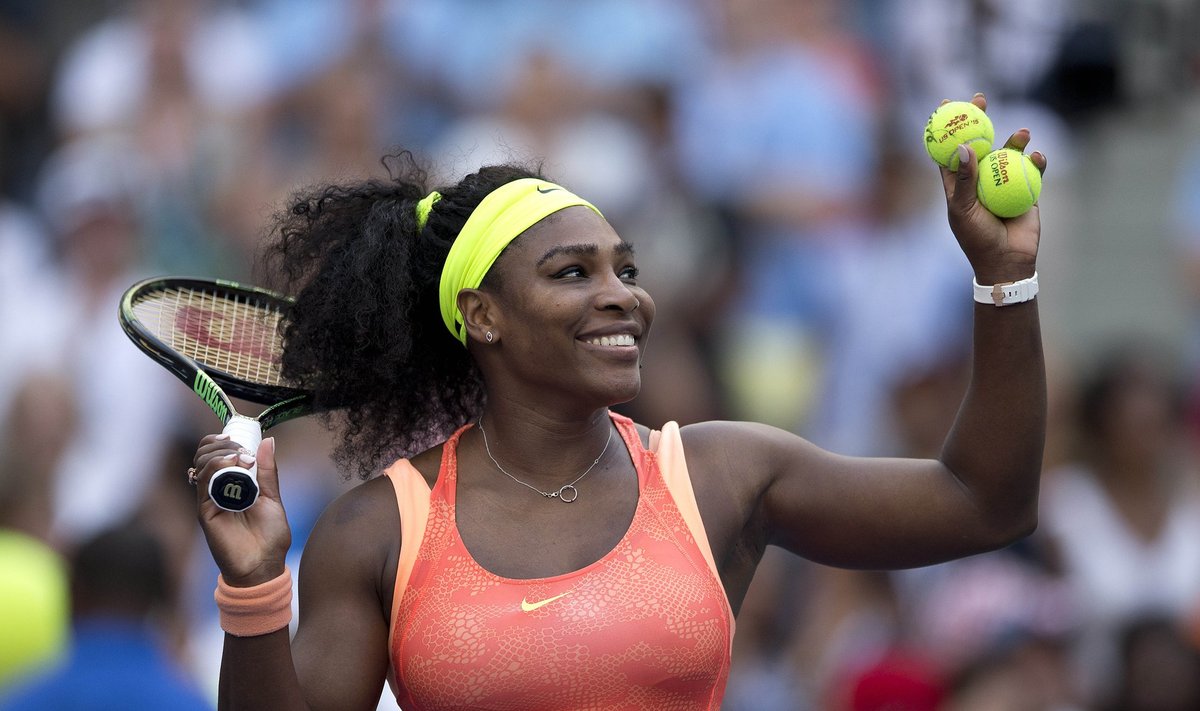 Williams of the U.S. hits tennis balls to the fans after defeating compatriot Keys in their fourth round match at the U.S. Open Championships tennis tournament in New York
