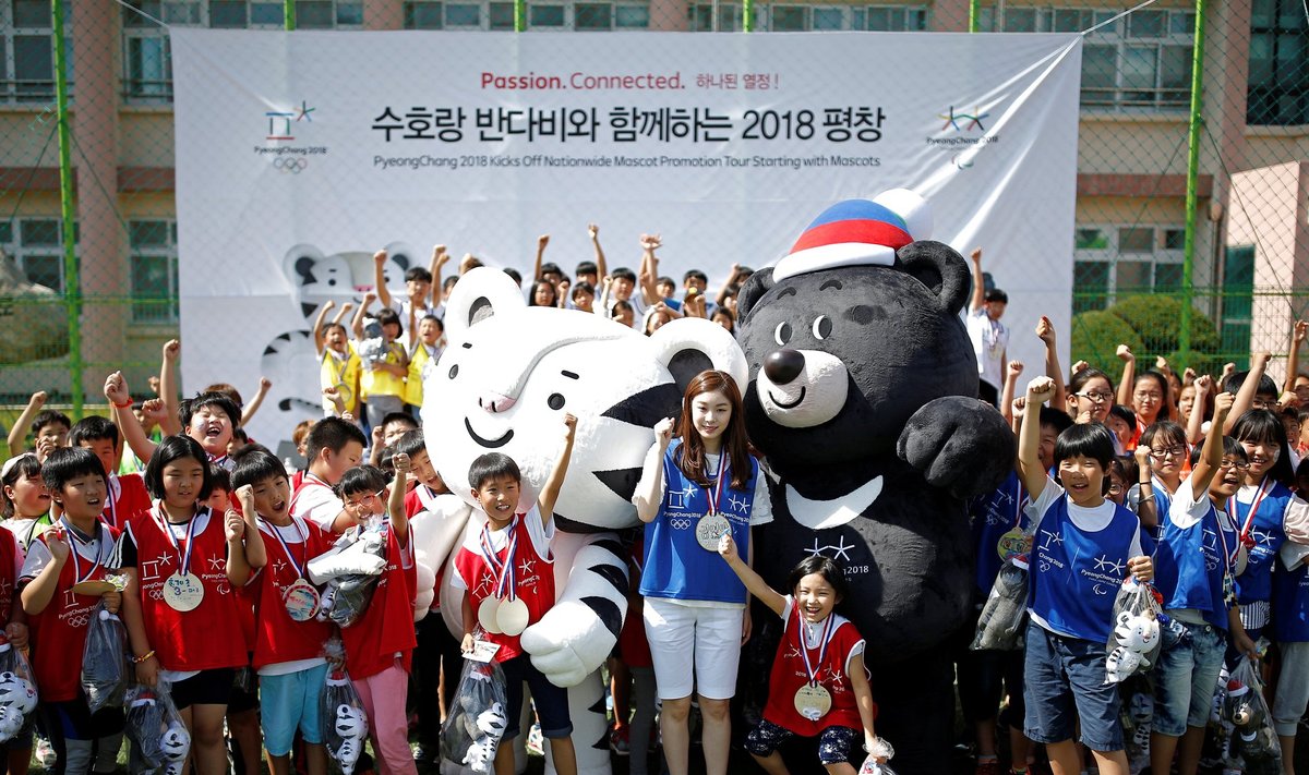The POCOG Honorary Ambassador Kim Yuna poses for photographs with mascots "Soohorang" and "Bandabi" during their launching ceremony in Pyeongchang