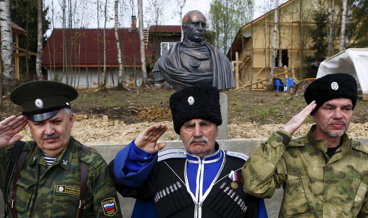 Cossacks salute during an unveiling ceremony for a bust of Russian President Putin which depicts him as a Roman emperor, in Leningrad region