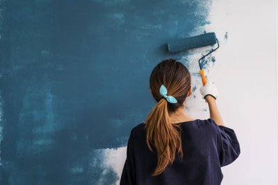 Young,Asian,Happy,Woman,Painting,Interior,Wall,With,Paint,Roller