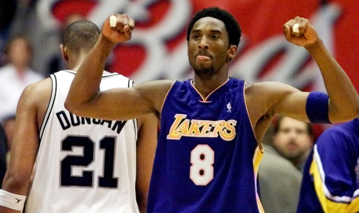 FILE PHOTO: Los Angeles Lakers guard Kobe Bryant celebrates while San Antonio Spurs forward Tim Duncan walks off disconsolately during Game 2 of the Western Conference Finals at the Alamodome in San Antonio.