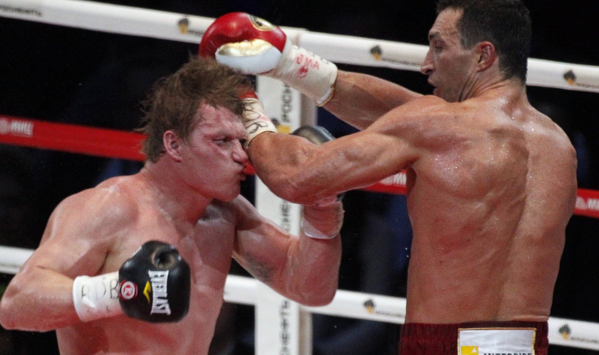 World heavyweight champion Klitschko of Ukraine punches challenger Povetkin of Russia during their heavyweight title fight in Moscow