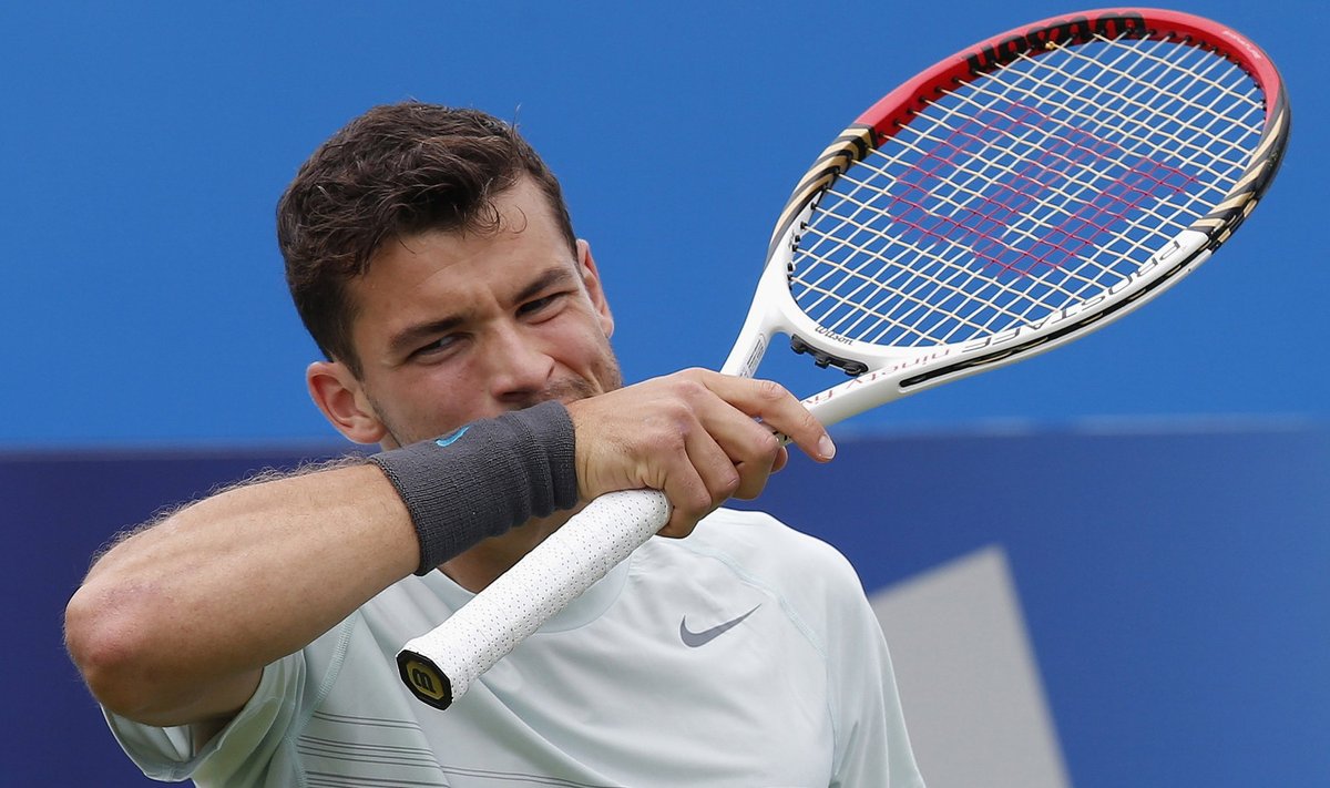 Bulgaria's Dimitrov wipes his face during his men's singles tennis match against Australia's Hewitt at the Queen's Club Championships in west London