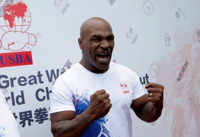 Former boxer Mike Tyson reacts as he speaks to the media on the outskirts of Beijing