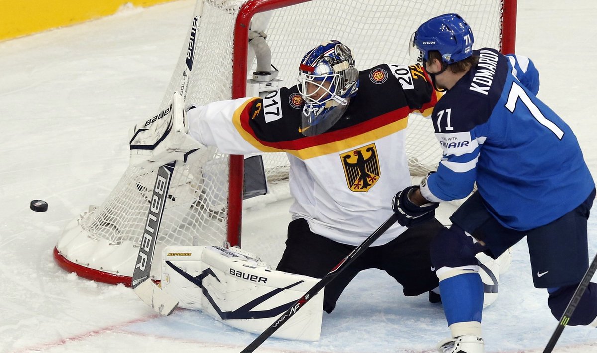 Germany's goalie Zepp saves in front of Finland's Komarov during the first period of their men's ice hockey World Championship Group B game at Minsk Arena in Minsk