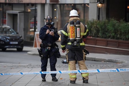 Police and rescue personnel are seen outside a company that received unidentified powder via mail, in central Stockholm