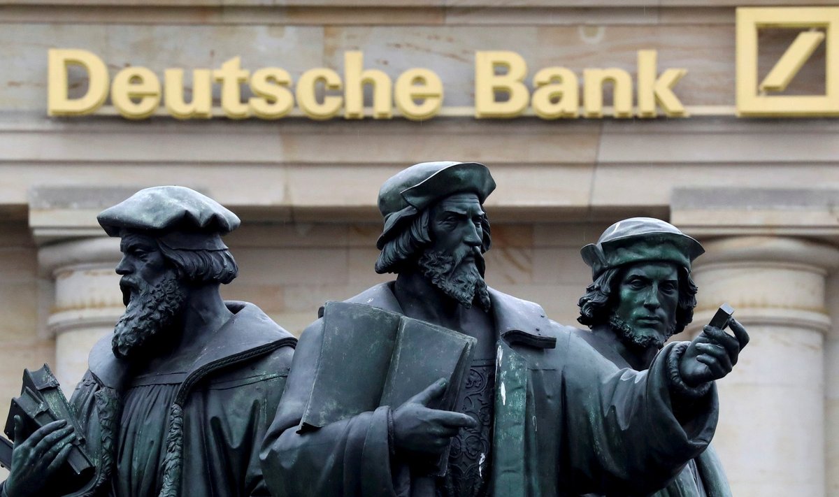 FILE PHOTO: A statue is pictured next to the logo of Germany's Deutsche Bank in Frankfurt