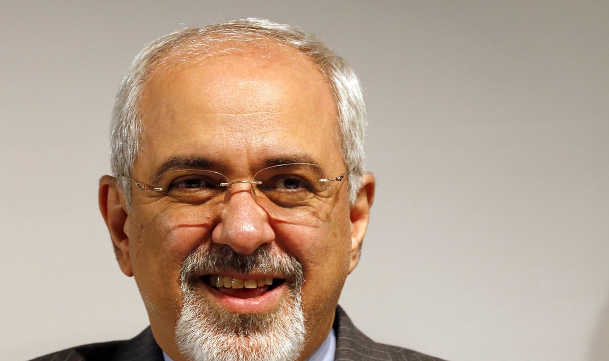 Iranian Foreign Minister Mohammad Zarif smiles during a news conference after nuclear talks at the United Nations European headquarters in Geneva