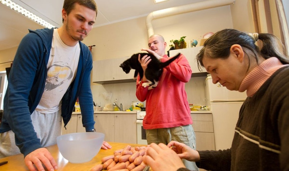 Sander Mättas (vasakul) aitab Tugiliisu päevakeskuse „noortel” lõunasööki valmistada. Pildil on temaga Oliver, Laine ja mullu lumehangest leitud kass Brusli Liisu.