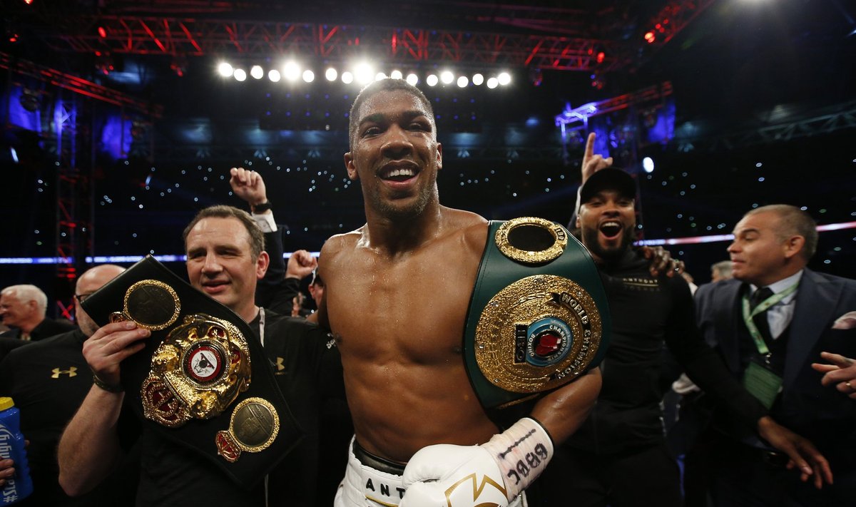 Anthony Joshua celebrates with trainer Robert McCracken after winning the fight