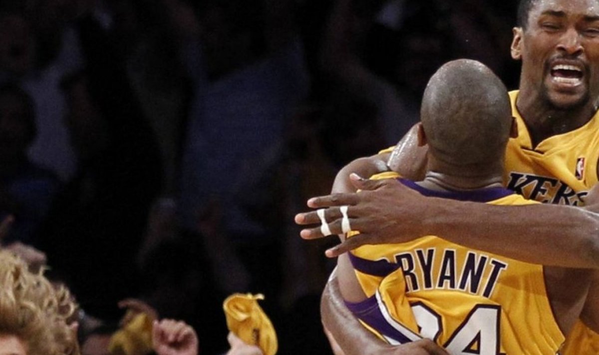 Los Angeles Lakers forward Ron Artest jumps into the arms of team-mate Kobe Bryant after scoring the game-winning basket against the Phoenix Suns with less than 1 second on the clock during Game 5 of their NBA Western Conference final playoffs in Los Angeles May 27, 2010. REUTERS/Lucy Nicholson (UNITED STATES - Tags: SPORT BASKETBALL IMAGES OF THE DAY)