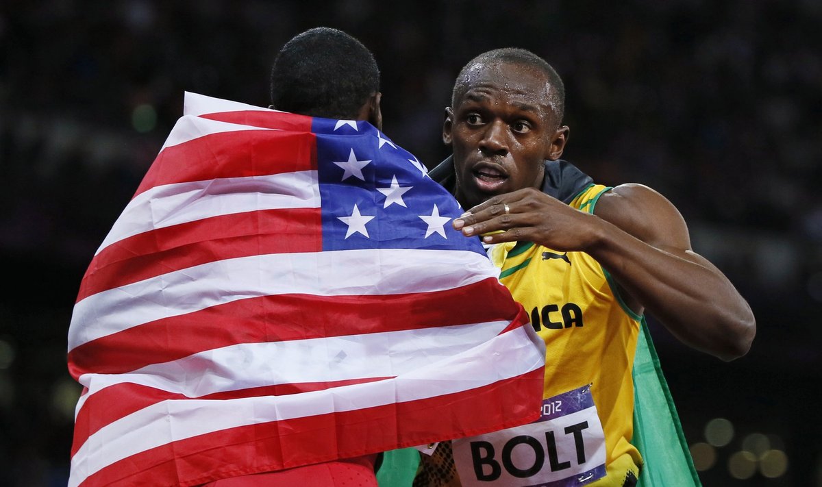 Jamaica's Usain Bolt (R) hugs Justin Gatlin of the U.S. after winning the men's 100m final with an Olympic record during the London 2012 Olympic Games at the Olympic Stadium