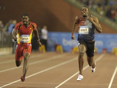 Bolt of Jamaica runs next to Gatlin of the U.S. on his way to win the men's 100 metres during the IAAF Diamond League athletics meeting in Brussels