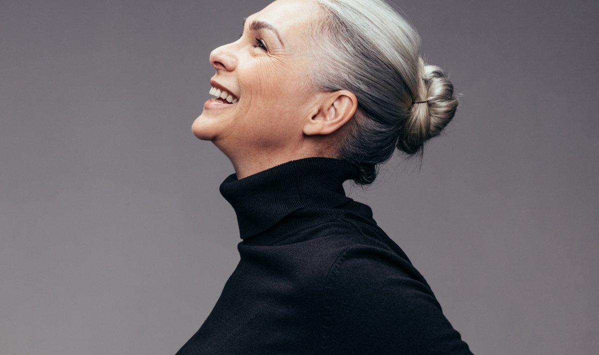 Side,View,Of,Senior,Woman,Laughing,On,Gray,Background.,Profile