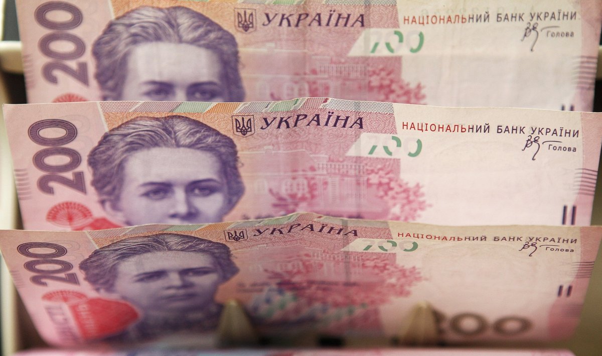 A cashier counts Ukrainian hryvnia banknotes at a shop in Kiev