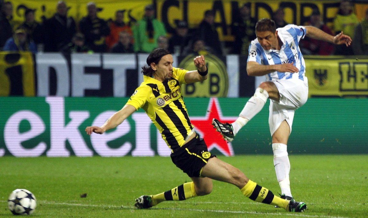 Malaga's Joaquin scores past Borussia Dortmund's Subotic during Champions League quarter-final second leg soccer match against Borussia Dortmund in Dortmund