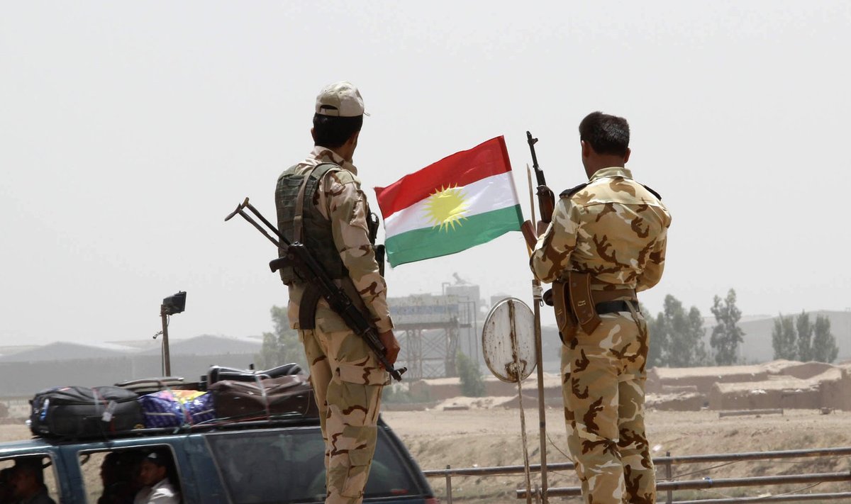 Members of the Kurdish security forces stand at a checkpoint during an intensive security deployment on the outskirts of Kirkuk 