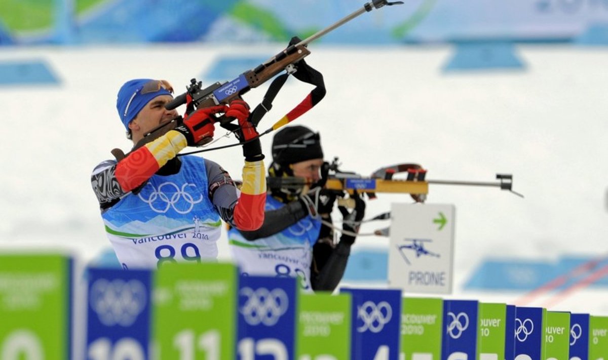 Germany's Michael Greis, left, and Athanassios Tsakiris, center, of Greece aim their rifles at the shooting range during an official training session at the Biathlon track at the Vancouver 2010 Olympics in Whistler, British Columbia, Monday, Feb. 15, 2010.  (AP Photo/Jin-man Lee) / SCANPIX Code: 436