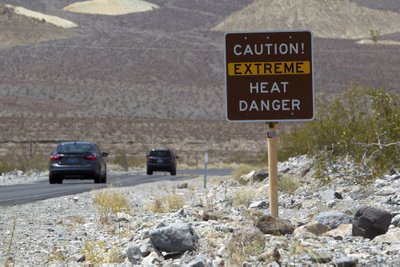 A sign warns of extreme heat as tourists enter Death Valley National Park in California