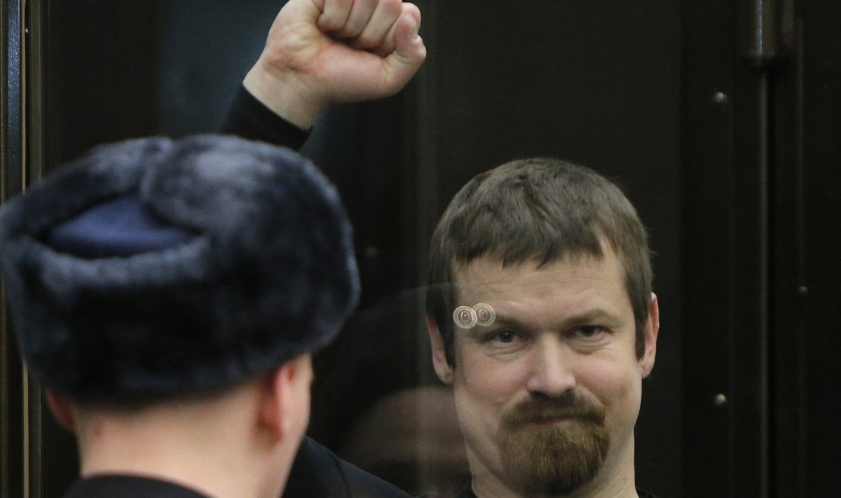 Co-defendant Razvozzhayev gestures from the defendants cage during a court hearing in Moscow
