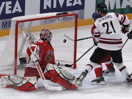 Latvia's Berzins scores past Czech Republic's goalkeeper Kovar during their 2012 IIHF men's ice hockey World Championship game in Stockholm