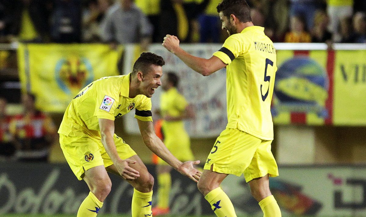 Villarreal's Paulista and Musacchio celebrate after their team scored a goal against Barcelona during their Spanish first division soccer match at the Madrigal stadium in Villarreal