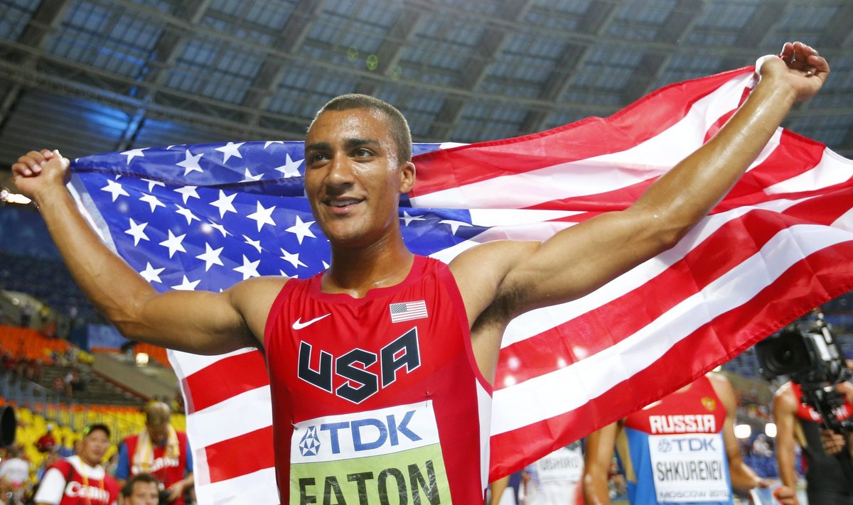 Eaton of the U.S. smiles as he holds his national flag after winning the men's decathlon during the IAAF World Athletics Championships at the Luzhniki stadium in Moscow