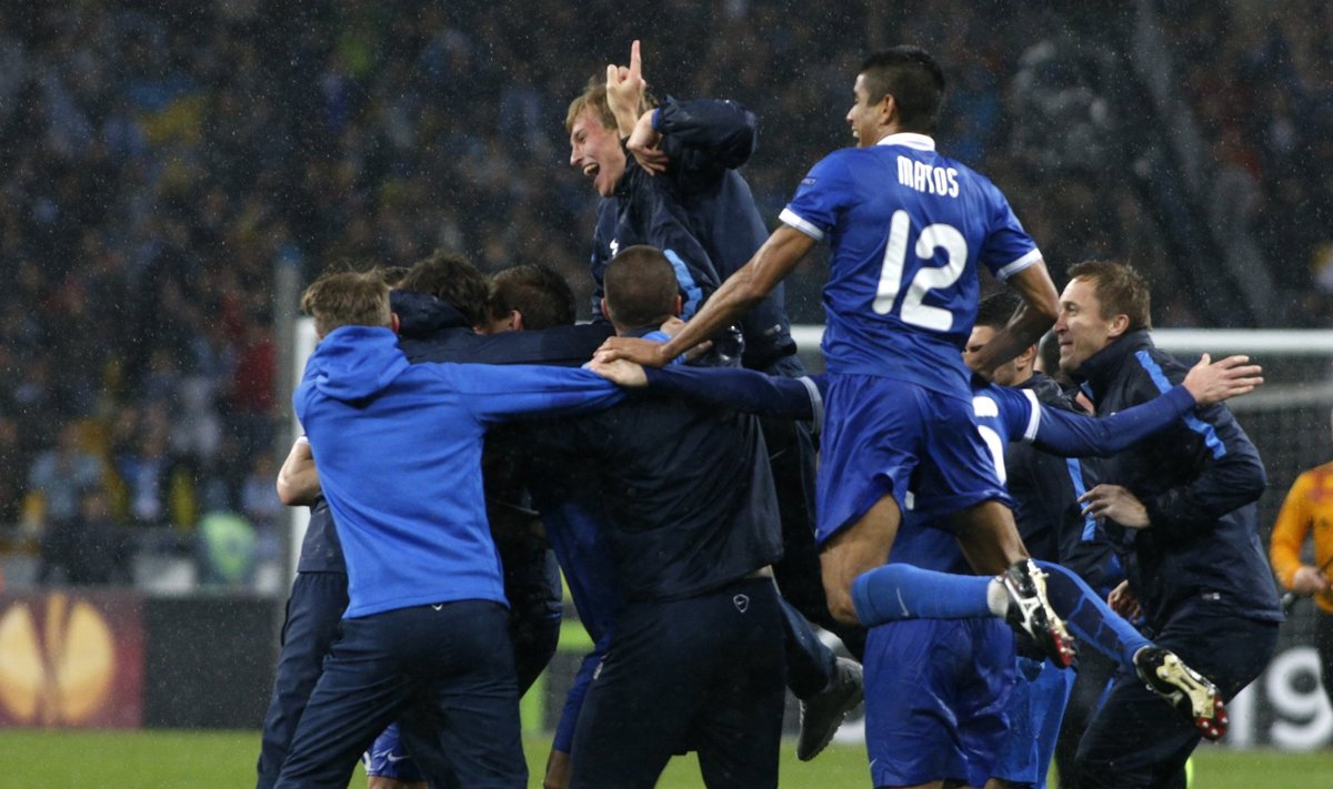 Dnipro Dnipropetrovsk's players, coaches and staff celebrate their victory over Napoli in the Europa League semi-final second leg soccer match at the Olympic stadium in Kiev