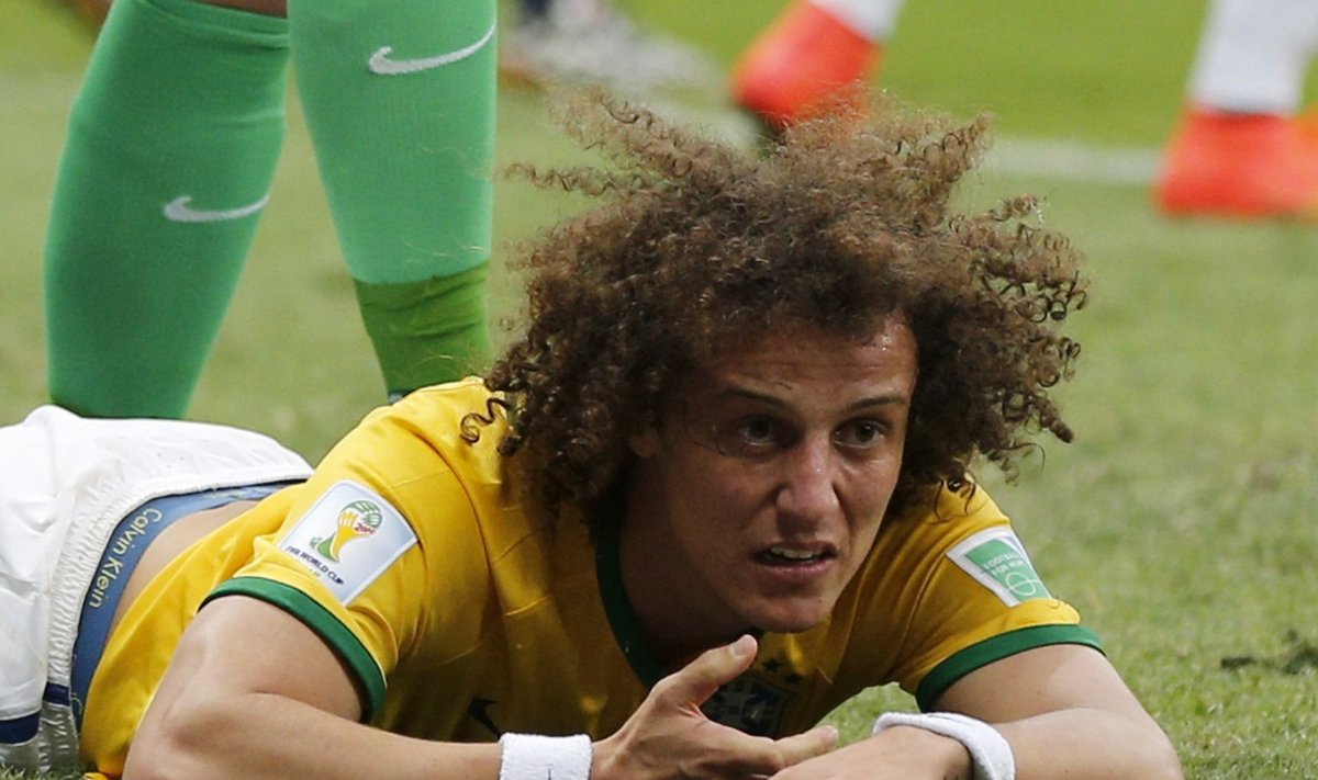 Brazil's David Luiz lies on the pitch after missing a goal during the 2014 World Cup third-place playoff between Brazil and the Netherlands at the Brasilia national stadium