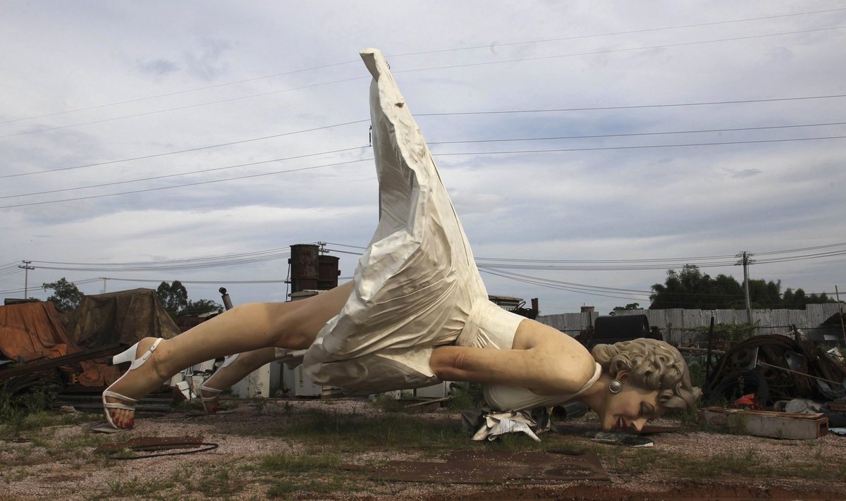 Giant statue of U.S. actress Marilyn Monroe is seen at the dump site of a garbage collecting company in Guigang
