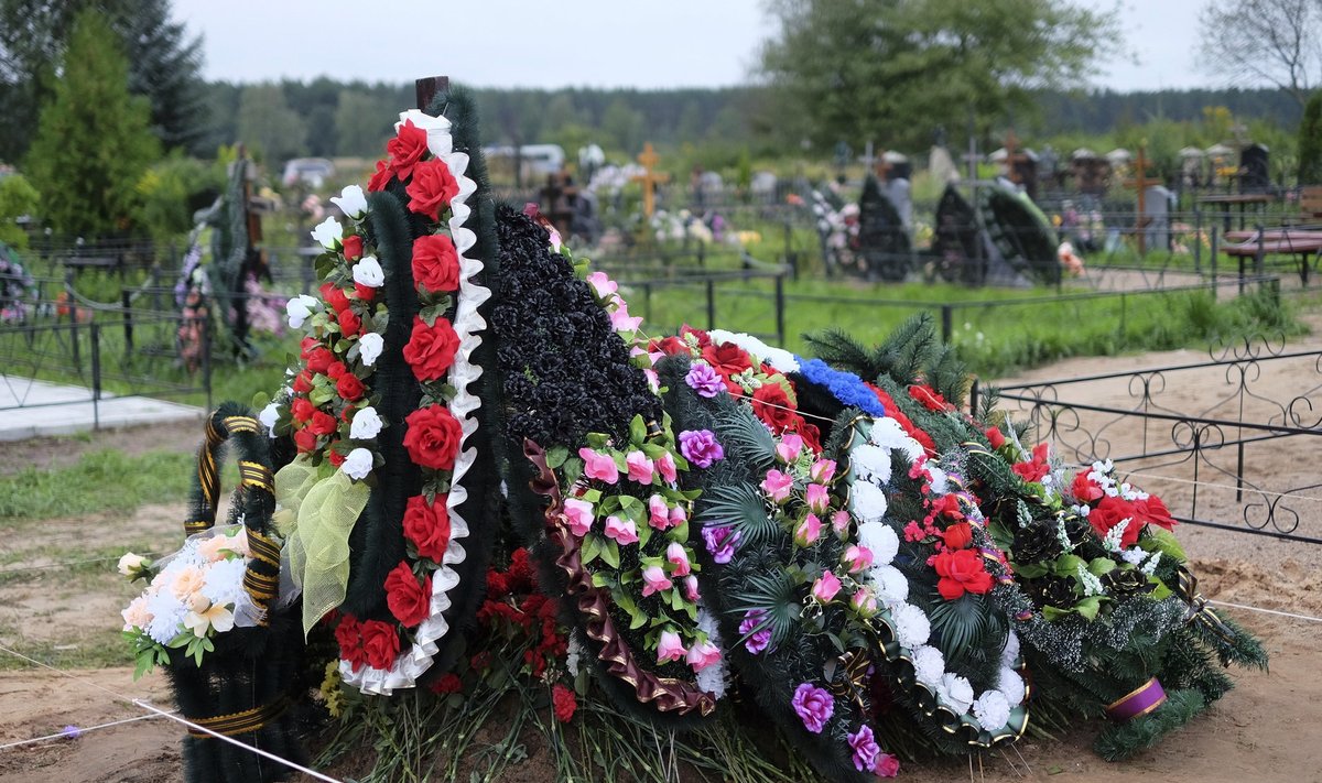 Freshly dug grave is seen at the Vybuty cemetery in the Pskov region