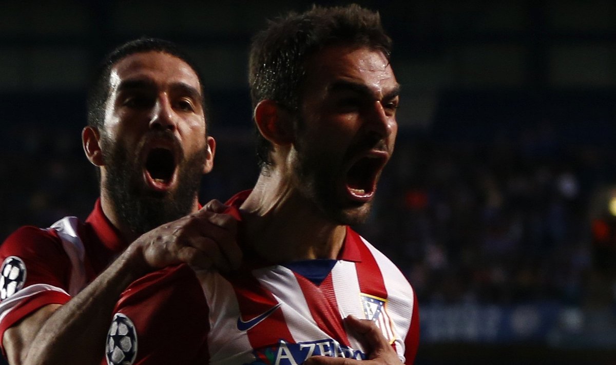 Atletico Madrid's Lopez celebrates with team mate Turan after scoring the first goal for the team during their Champions League semi-final second leg soccer match against Chelsea at Stamford Bridge Stadium in London