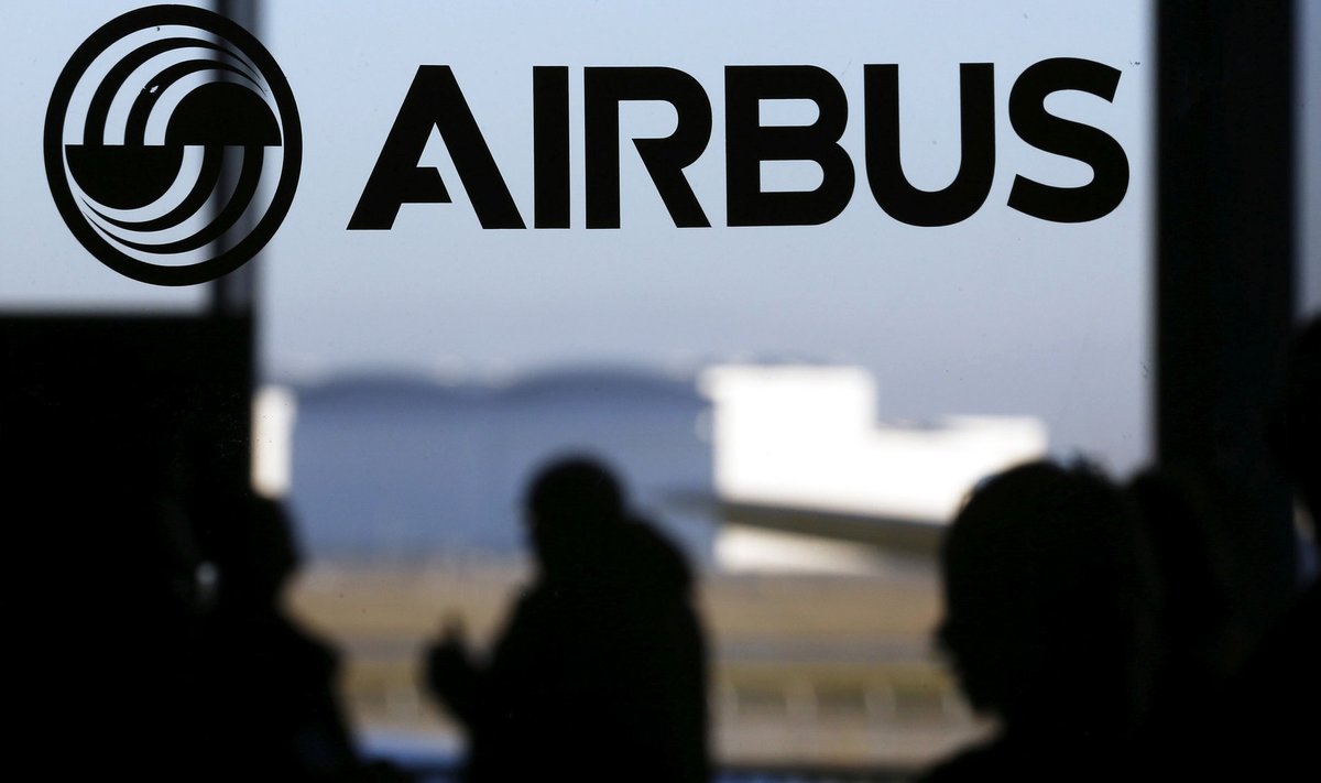 File photo of people passing logo of Airbus Group in Colomiers