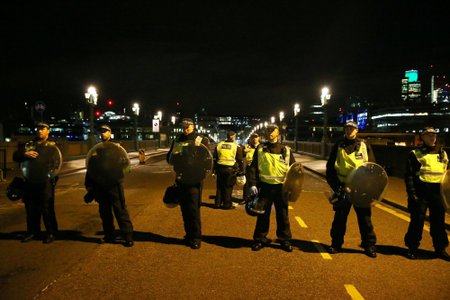 Police officers guard the approach to Southwark Bridge after an incident near London Bridge in London