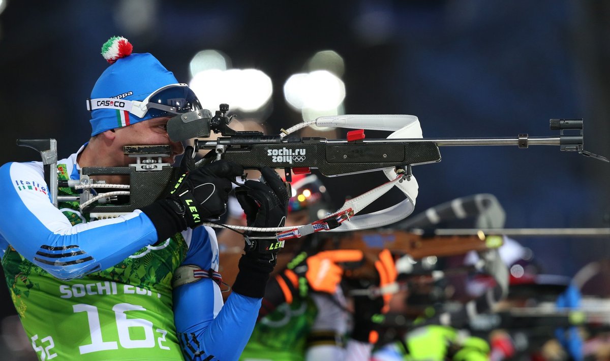 Italy's Windisch shoots during men's biathlon 4 x 7.5 km relay at Sochi 2014 Winter Olympic Games