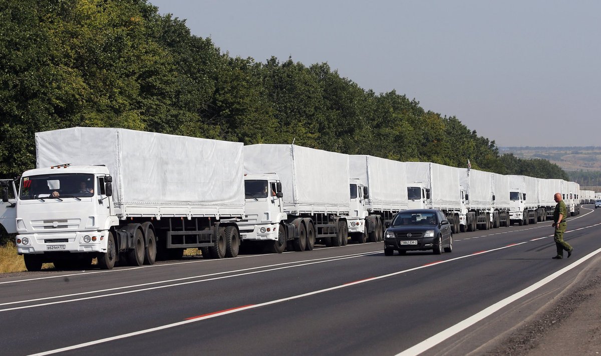 A Russian convoy of trucks carrying humanitarian aid for Ukraine is parked on the roadside near Millerovo