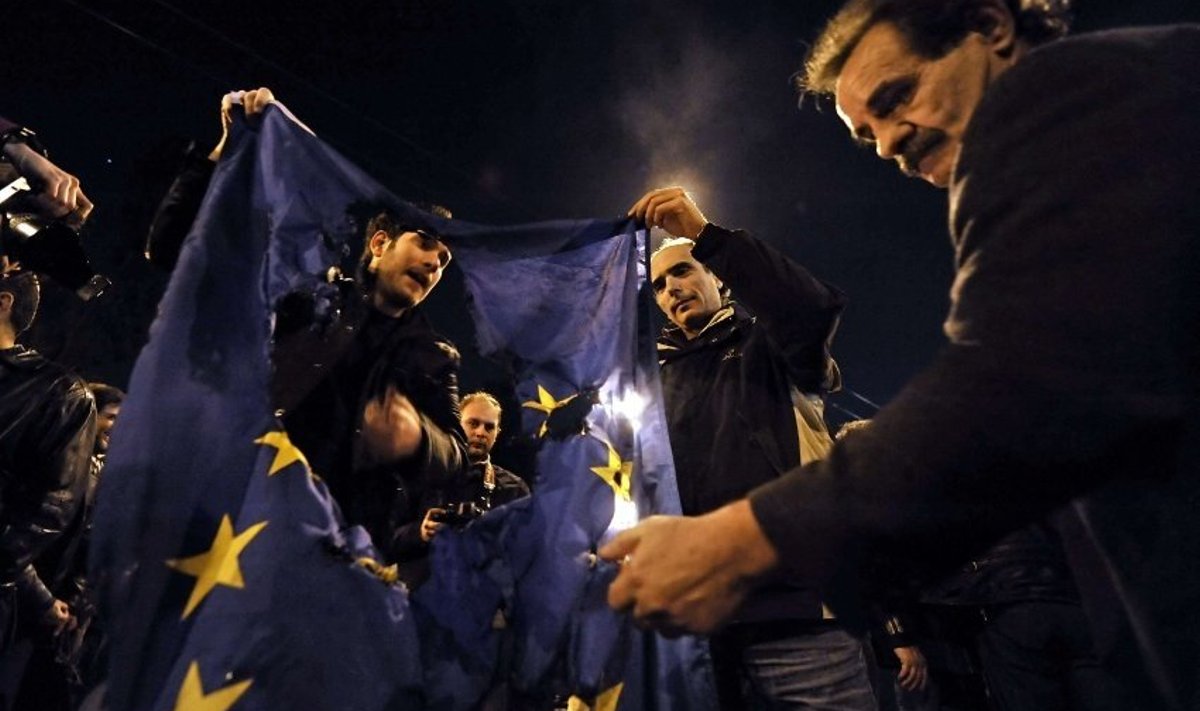 Demonstrators burn an EU flag near the EU offices in Athens, during a  march on March 4, 2010 to protest against austerity measures announced by the Greek government. Greece has frozen pensions and raised a string of taxes to cut spending by 4.8 billion euros in a frantic bid to persuade its EU partners and the markets that it can dodge bankruptcy AFP PHOTO / Louisa Gouliamaki
