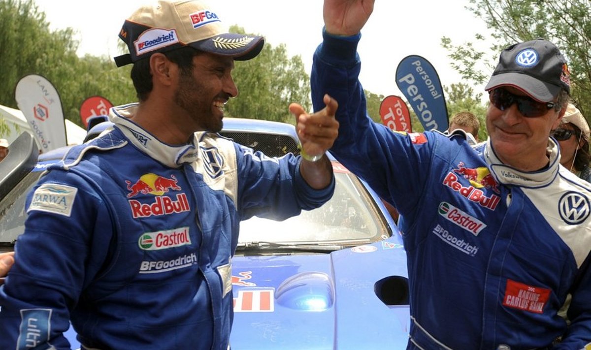 Spain's Carlos Sainz (R) is congratulated by his teammate Qatar?s Nasser Al-Attiyah after the 14th stage of the Dakar 2010, between Santa Rosa and Buenos Aires, Argentina on January 16, 2010. Spain's Carlos Sainz won the Dakar 2010 ahead of his Volkswagen's teammates Qatar?s Nasser Al-Attiyah and US' Mark Miller. Nasser Al-Attiyah won the last stage, Carlos Sainz took the second place and France's Guerlain Chicherit finished third.  AFP PHOTO / GABRIEL BOUYS