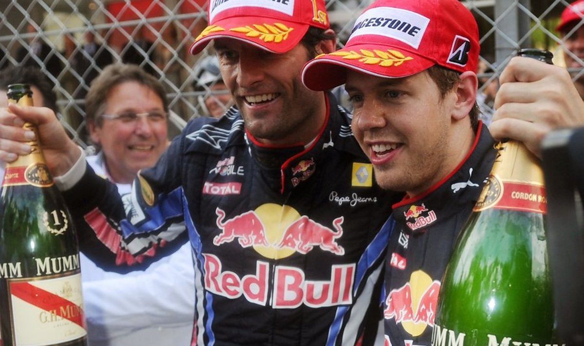 Red Bull's Australian driver Mark Webber (L) celebrates with Red Bull's German driver Sebastian Vettel at the Monaco street circuit on May 16, 2010, after the Monaco Formula One Grand Prix. Red Bull's Australian driver Mark Webber won the race ahead of Red Bull's German driver Sebastian Vettel and Renault f1's Polish driver Robert Kubica.                            AFP PHOTO / FRED DUFOUR