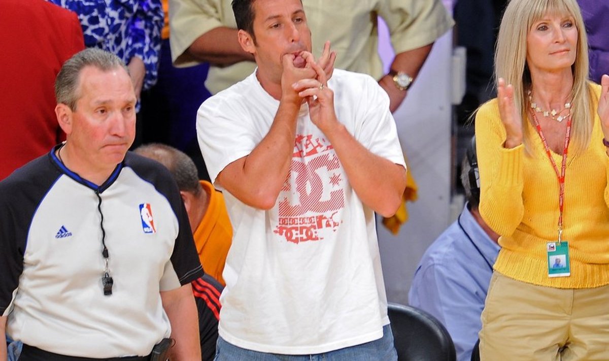 Actor Adam Sandler (C) whistles from his courtside seat during Game 1 of the NBA Finals between the Los Angeles Lakers and the Boston Celtics at the Staples Center in Los Angeles, California in Los Angeles, California on June 3, 2010.  AFP PHOTO / ROBYN BECK
