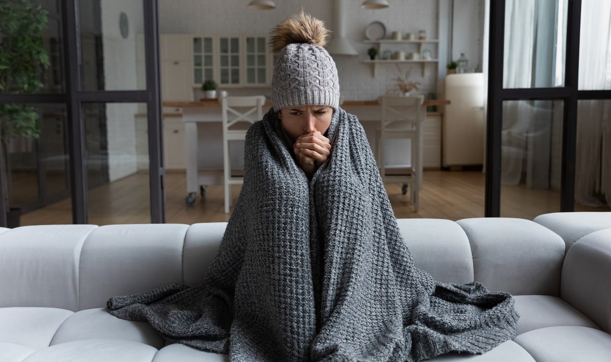 Frozen.,Sad,Latina,Female,Sit,On,Couch,At,Freezing,Cooled