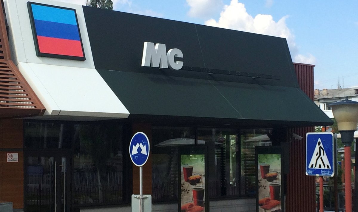 Letters "Mc" and flag of self-proclaimed Luhansk People's Republic are seen on building which before housed McDonald's restaurant in Luhansk