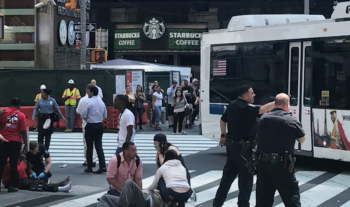 First responders are at the scene as people help injured pedestrians after a vehicle struck pedestrians on a sidewalk in Times Square in New York
