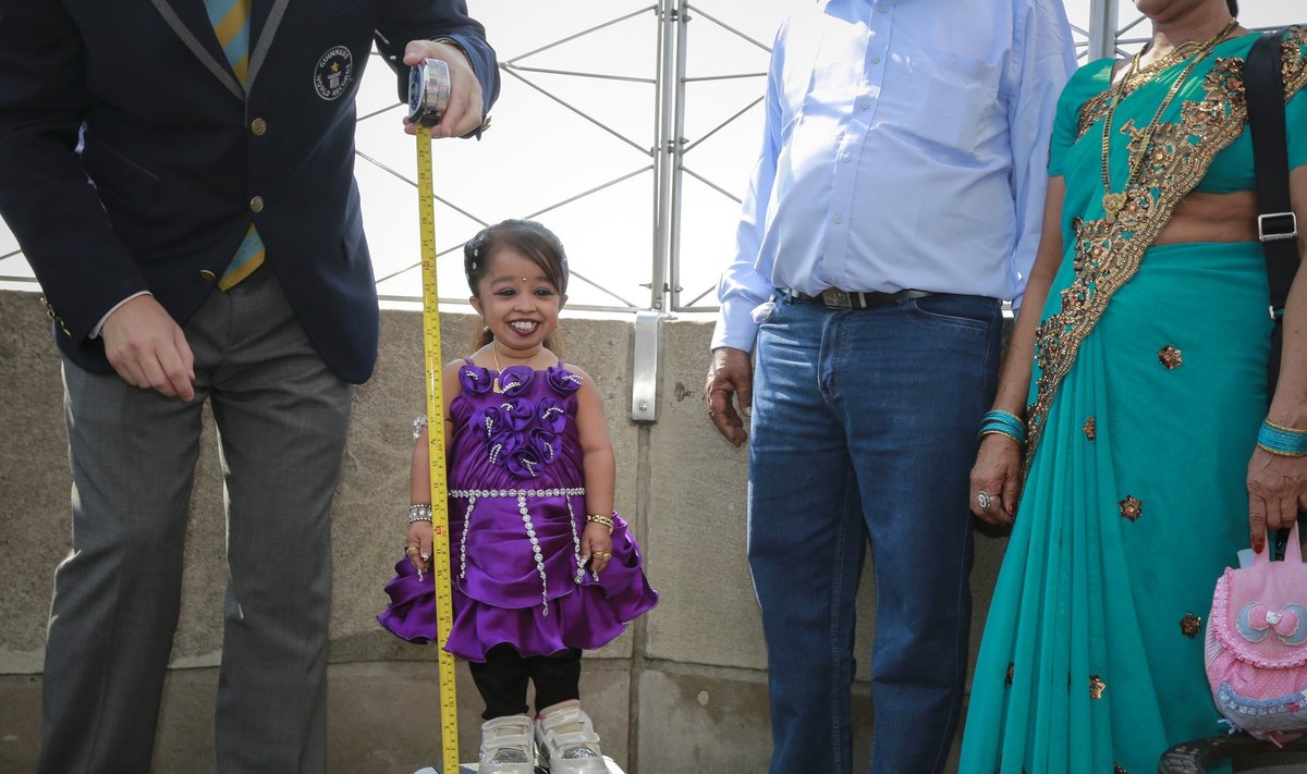 Jyoti Amge is measured by a Guinness World Record official on top of the Empire State Building in New York