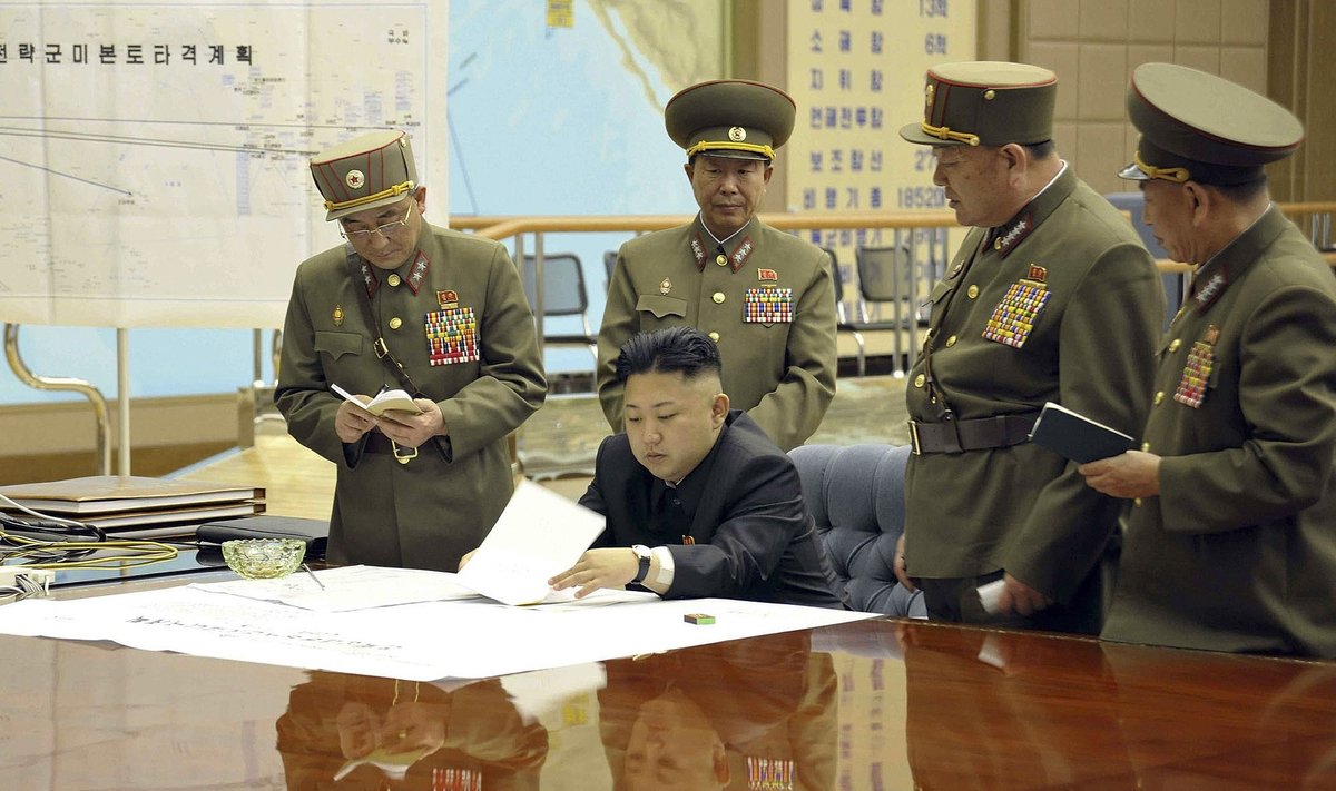 This photo taken and released by North Korea's official Korean Central News Agency (KCNA) on March 29, 2013 shows, according to KCNA, North Korean leader Kim Jong-Un discussing the strike plan with North Korean officers during an urgent operation meeting at the Supreme Command in an undisclosed location.  North Korean leader Kim Jong-Un ordered preparations for strategic rocket strikes on the US mainland and military bases in the Pacific and South Korea. The lettering on the map, rear L, reads as "Strategic Forces' US Mainland Striking Plan".    AFP PHOTO / KCNA via KNS ..THIS PICTURE WAS MADE AVAILABLE BY A THIRD PARTY. AFP CAN NOT INDEPENDENTLY VERIFY THE AUTHENTICITY, LOCATION, DATE, AND CONTENT  OF THIS IMAGE. THIS PHOTO IS DISTRIBUTED EXACTLY AS RECEIVED BY AFP. ..RESTRICTED TO EDITORIAL USE - MANDATORY CREDIT  " AFP PHOTO / KCNA via KNS " - NO MARKETING NO ADVERTISING CAMPAIGNS - DISTRIBUTED AS A SERVICE OT CLIENTS